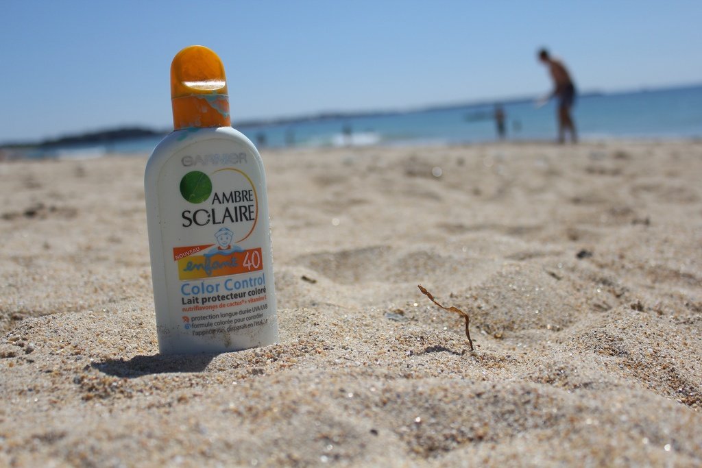 bottle of spf 40 sunscreen on the beach