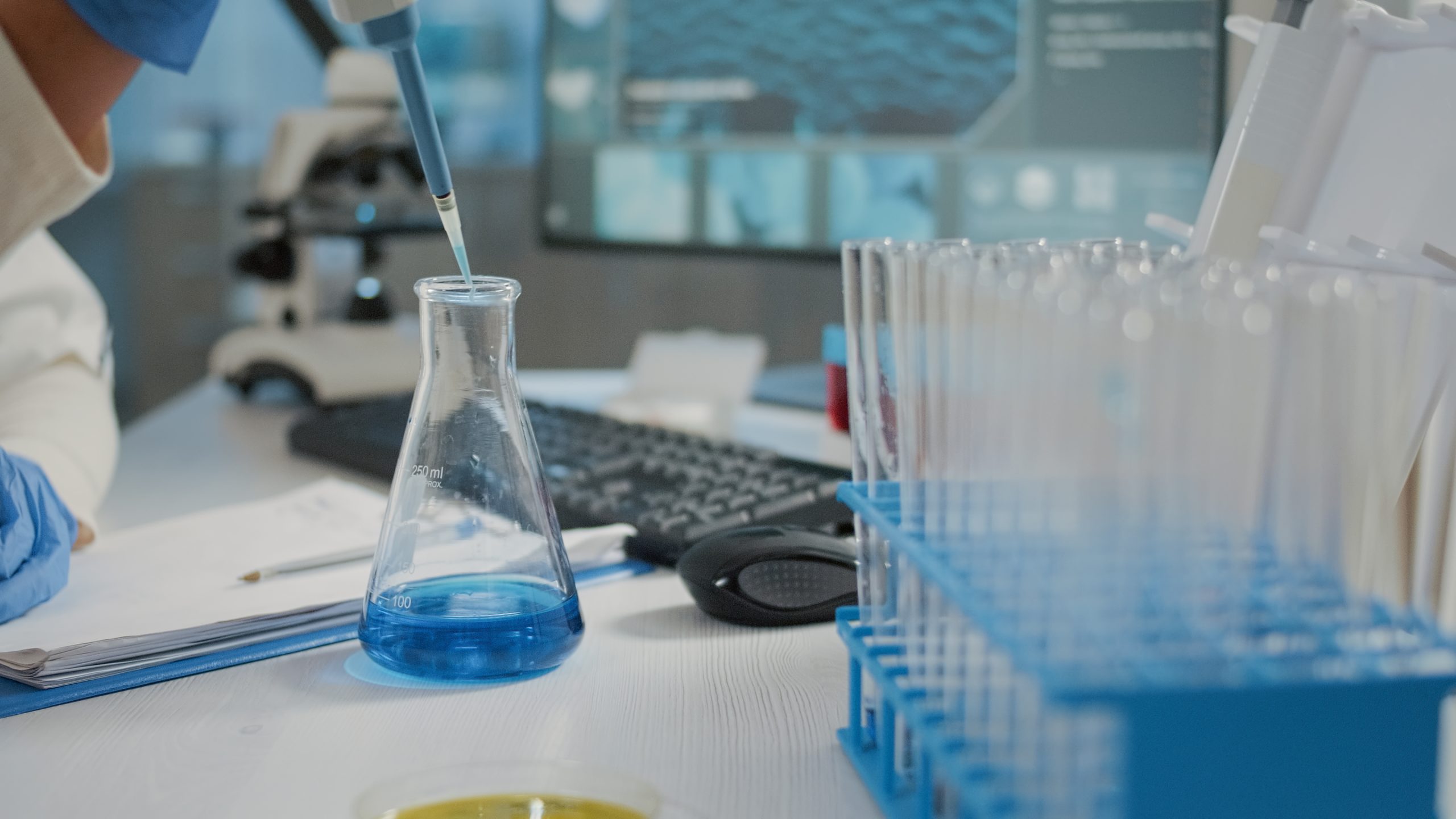 Chemical engineer putting chemical solution in a beaker