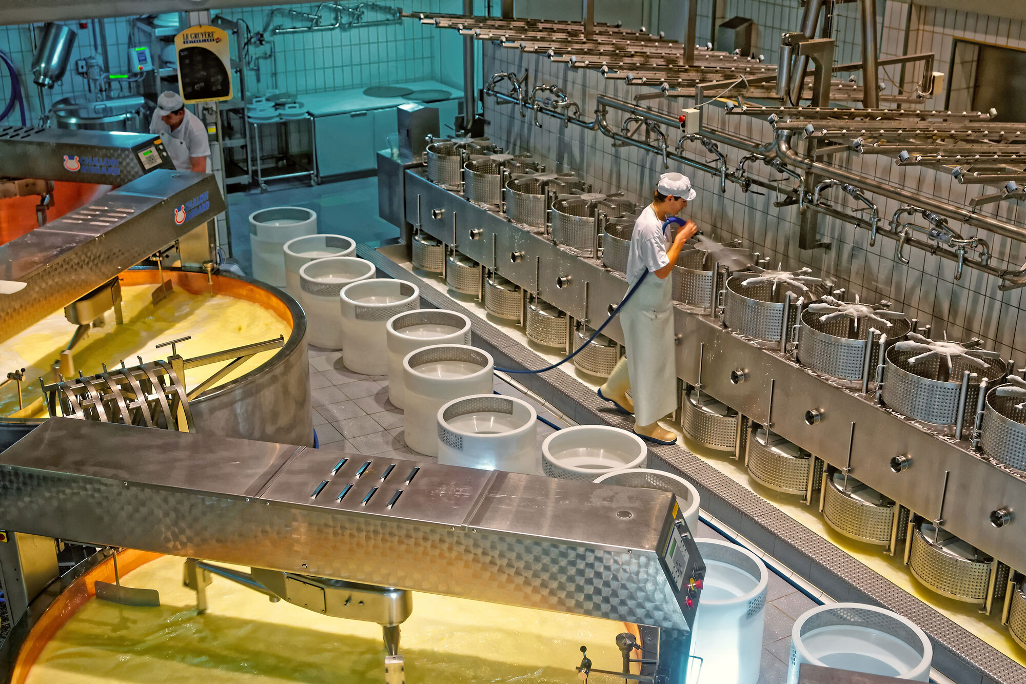 man cleaning vats in a cheese factory with a CIP system