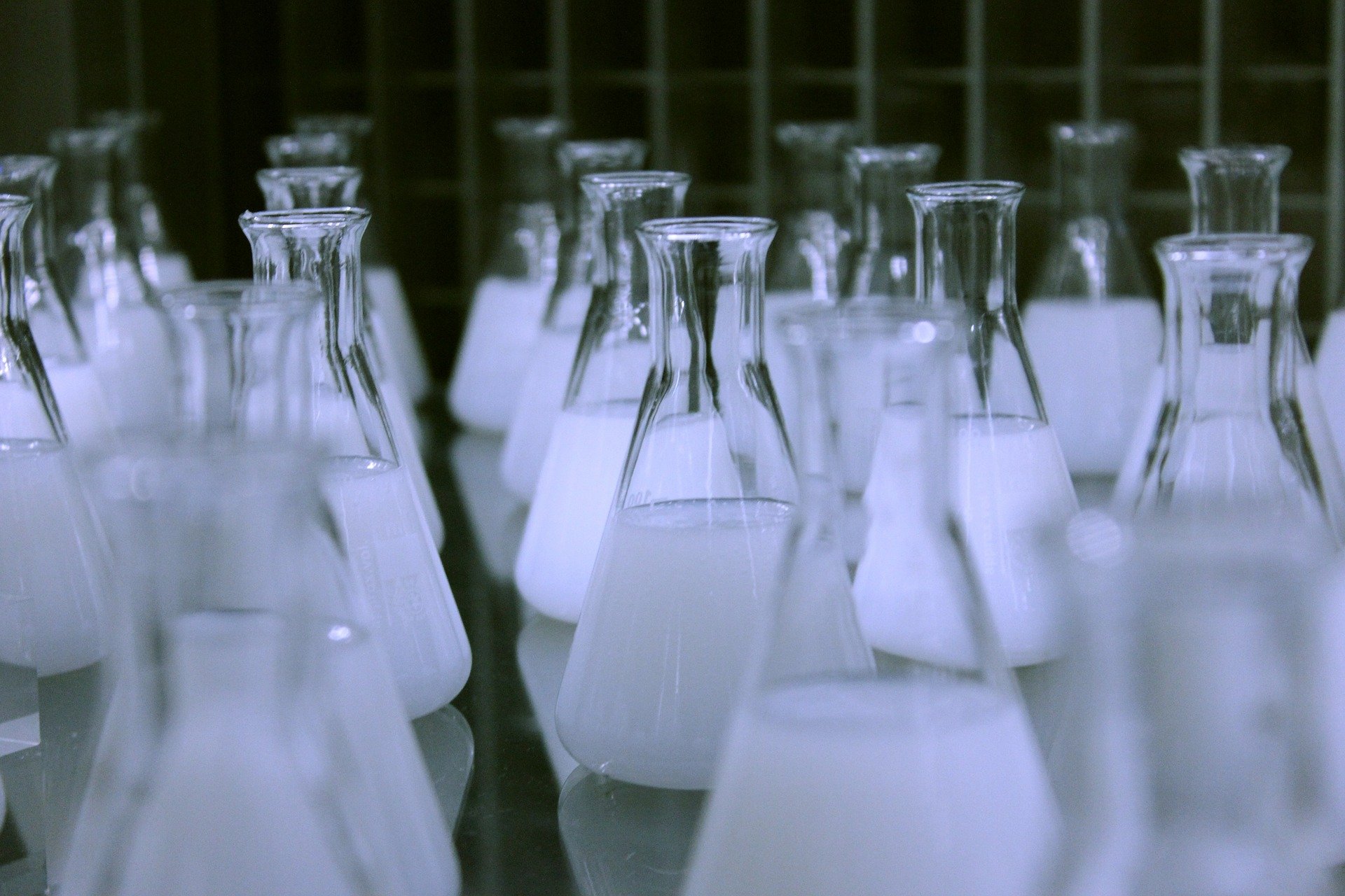 rows of conical flasks filled with chemicals