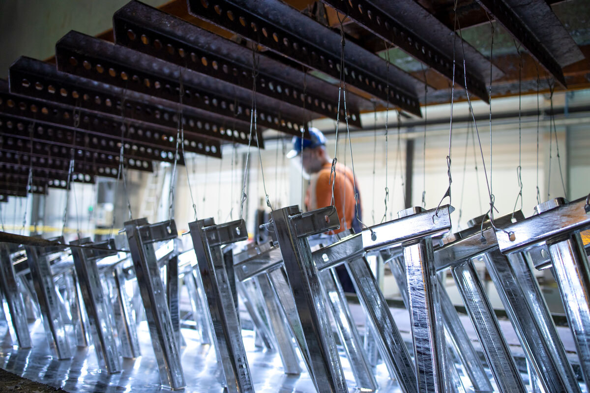 metal being treated with zinc by hot dip galvanzing