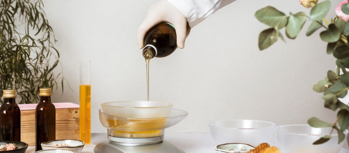 chemist pouring chemical into batch of soap